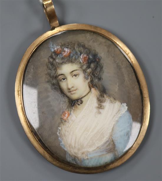 A 19th century Continental oil on ivory miniature of a lady with flower in her hair 4.5 x 4cm, gold framed